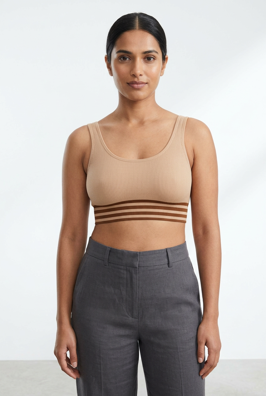 Adult model wearing a beige ribbed seamless bralette with a brown striped band