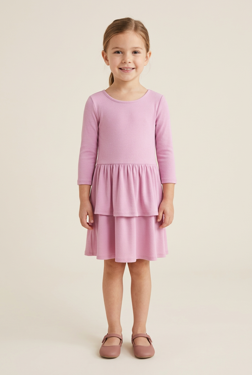 Child model wearing a pink ribbed-knit tiered ruffle dress